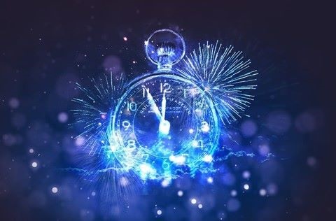 Clock showing five minutes to 12 with fireworks in background